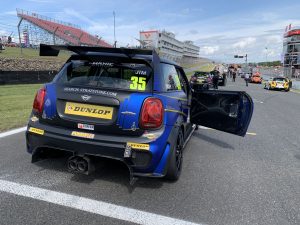 Mini on track with car door open